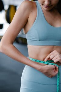 Woman checking if her waistline has gone down